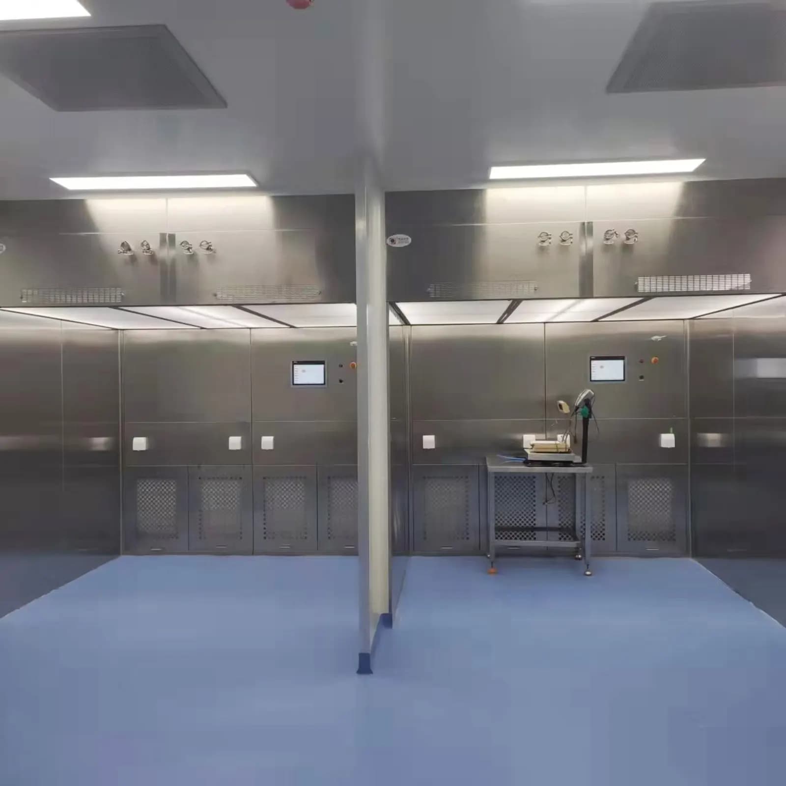 Twin dispensing booths in a controlled production area