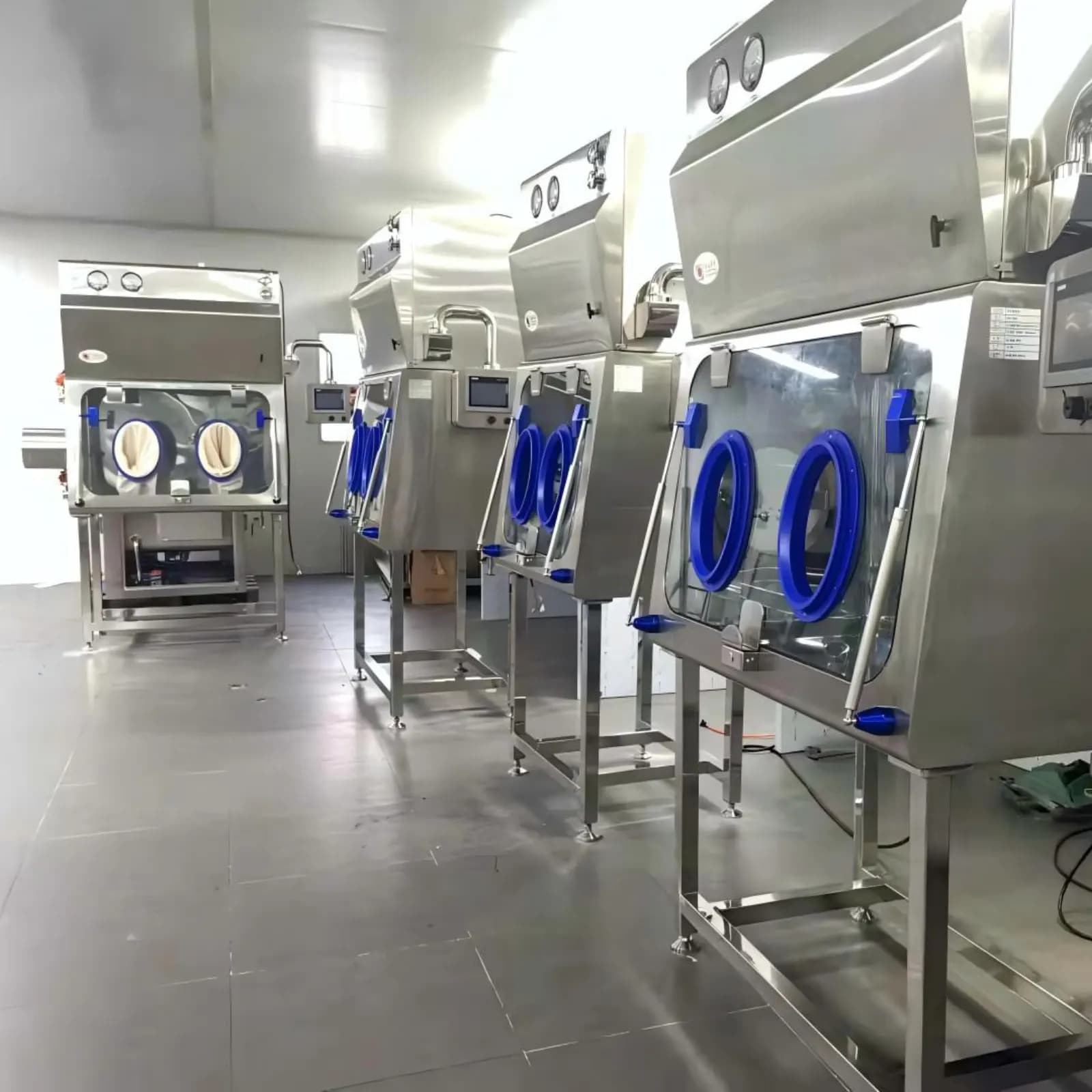 Multiple negative pressure isolators arranged in a clean production room
